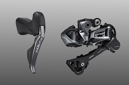 Shimano GRX bike shifter and derailleur on a gray background