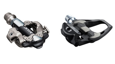 Two Shimano bike pedals, one XTR mountain bike clipless pedal and one Ultegra road bike clipless pedal.