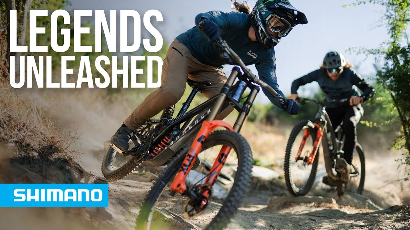 Mountain bikers riding down a trail with text Legends Unleashed and Shimano logo