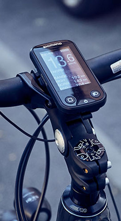 Close-up of a bicycle handlebar with a digital display showing speed and distance