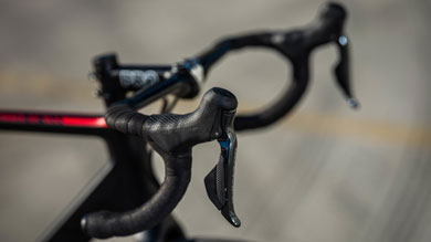 Close-up of bicycle handlebars and brake levers with blurred background