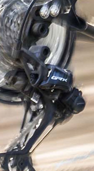 Close-up of a spinning bicycle wheel and derailleur in motion