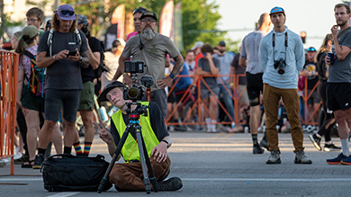 Film maker shooting the finishline at Unbound Gravel bike race 2024